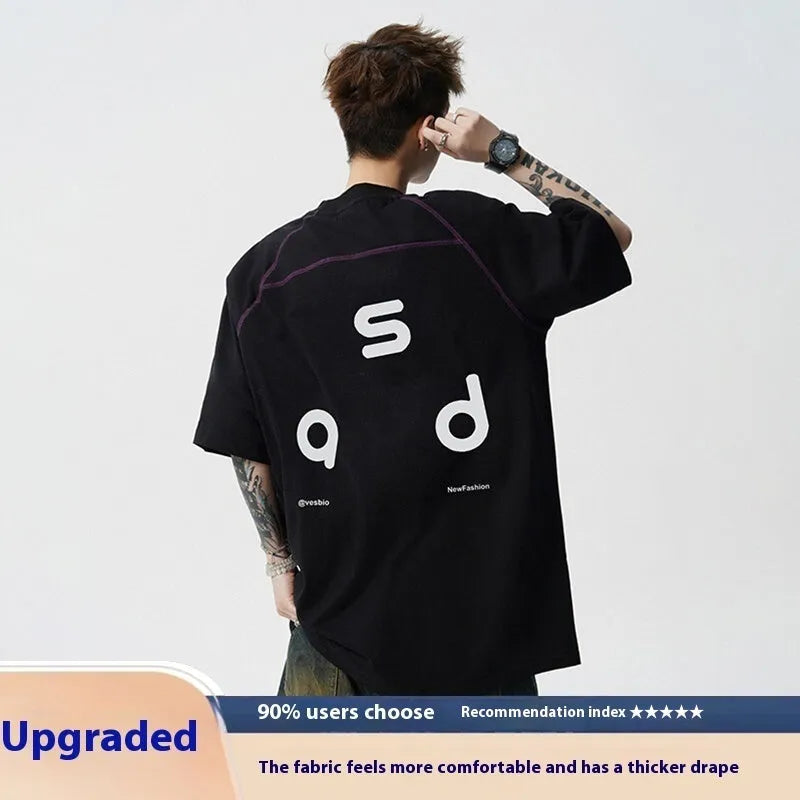 Black loose fit cotton T-shirt with white letter print on front, short sleeves and round neck.