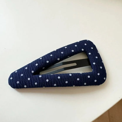 French retro dot pattern barrettes in triangle and water drop shapes with dark denim styling