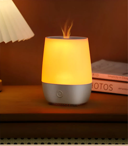 White USB aroma diffuser humidifier with simulated flame light effect on a table.