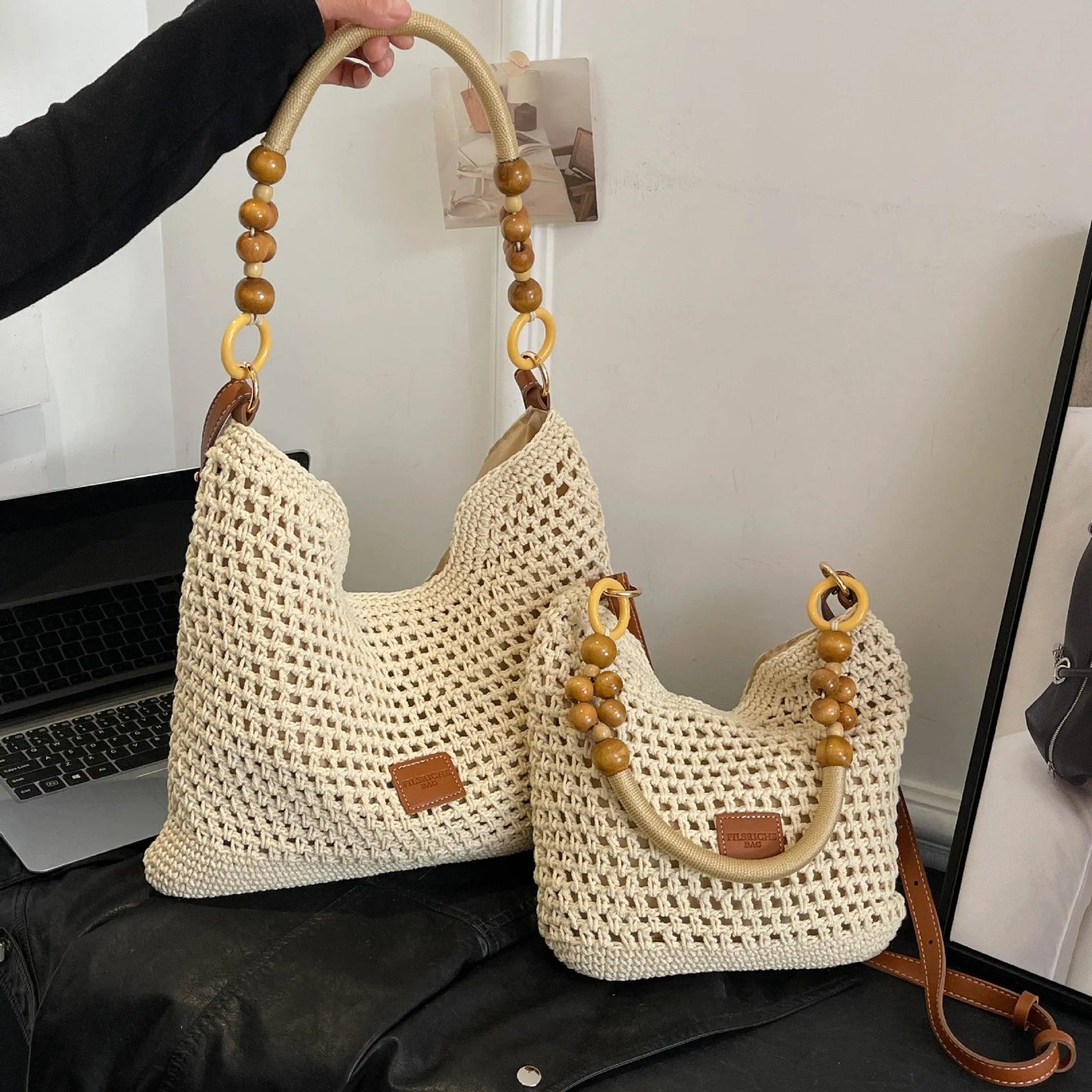 Large brown knitted bucket tote beach bag with contrast stitching and a zip internal compartment.