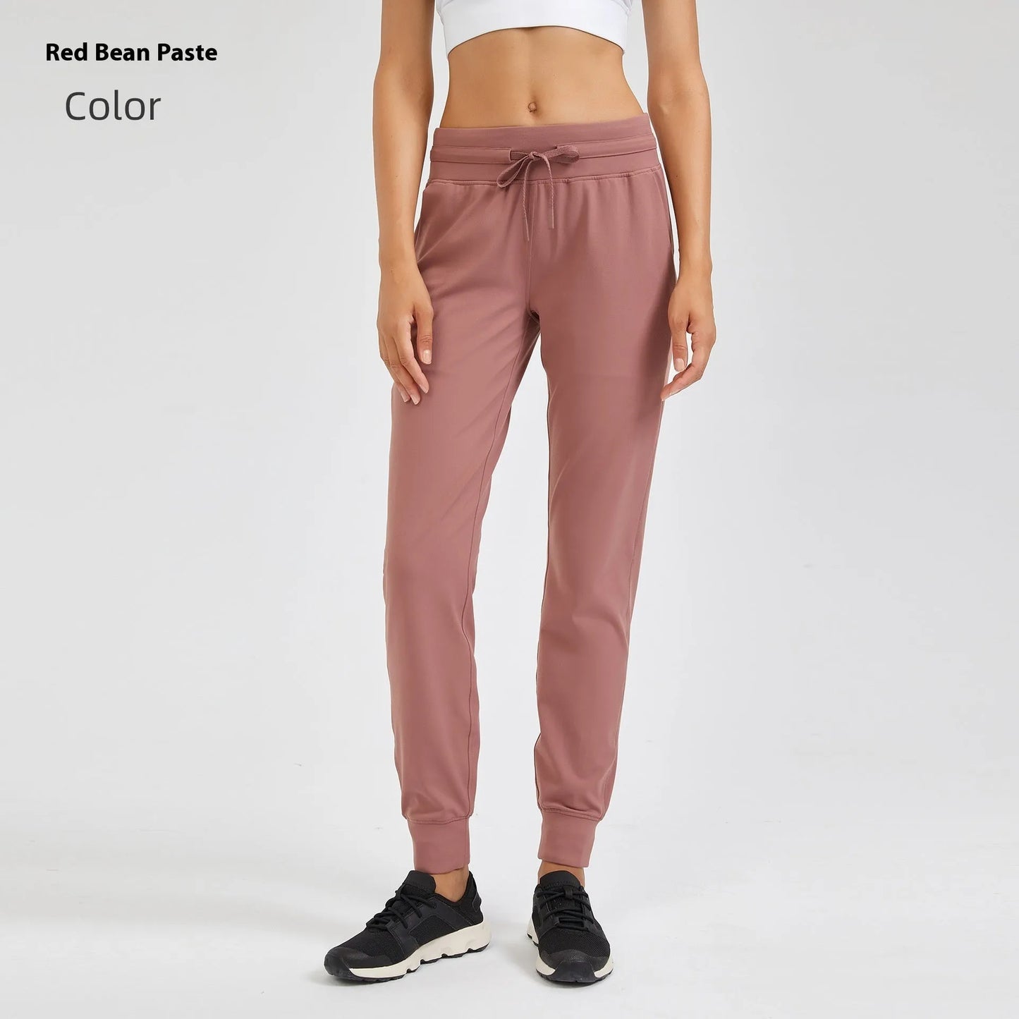 Women's high waist yoga pants with drawstring waistband in Belgian blue colour, showing stretch fabric during yoga pose