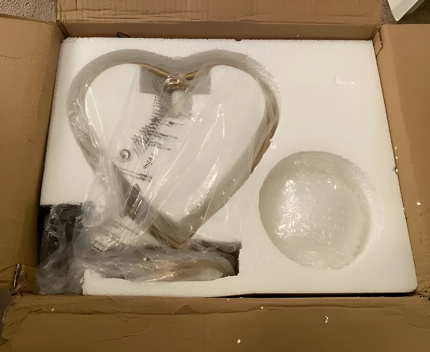 Heart-shaped polyresin table lamp with warm white LED light on a wooden surface
