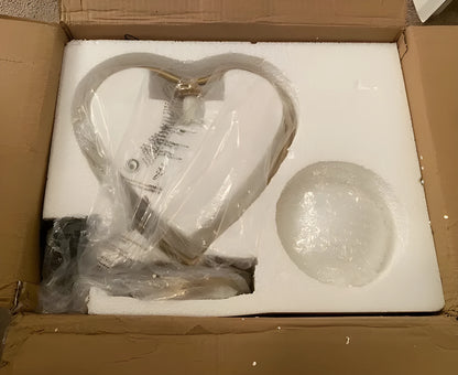 Heart-shaped polyresin table lamp with warm white LED light on a wooden surface
