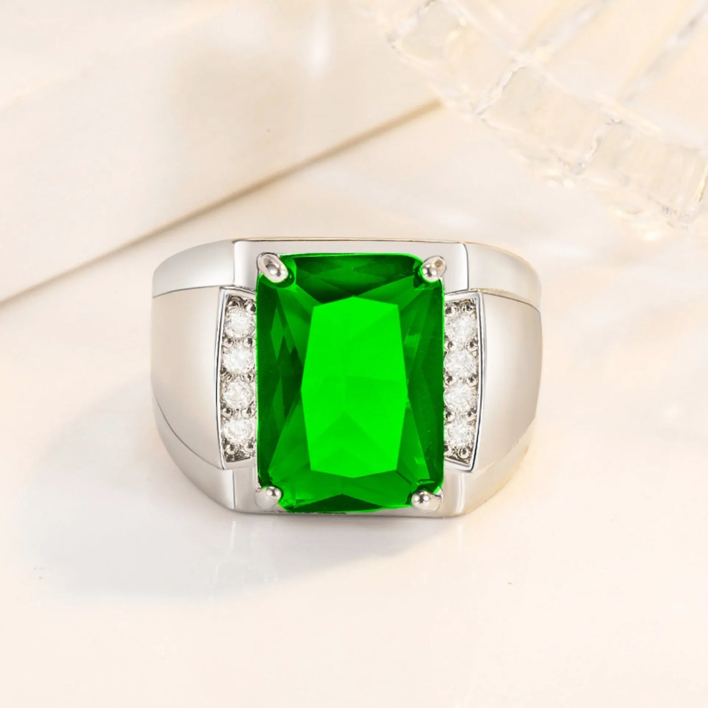 Open geometric adjustable ring with coloured gemstones on a copper band with metallic plating.