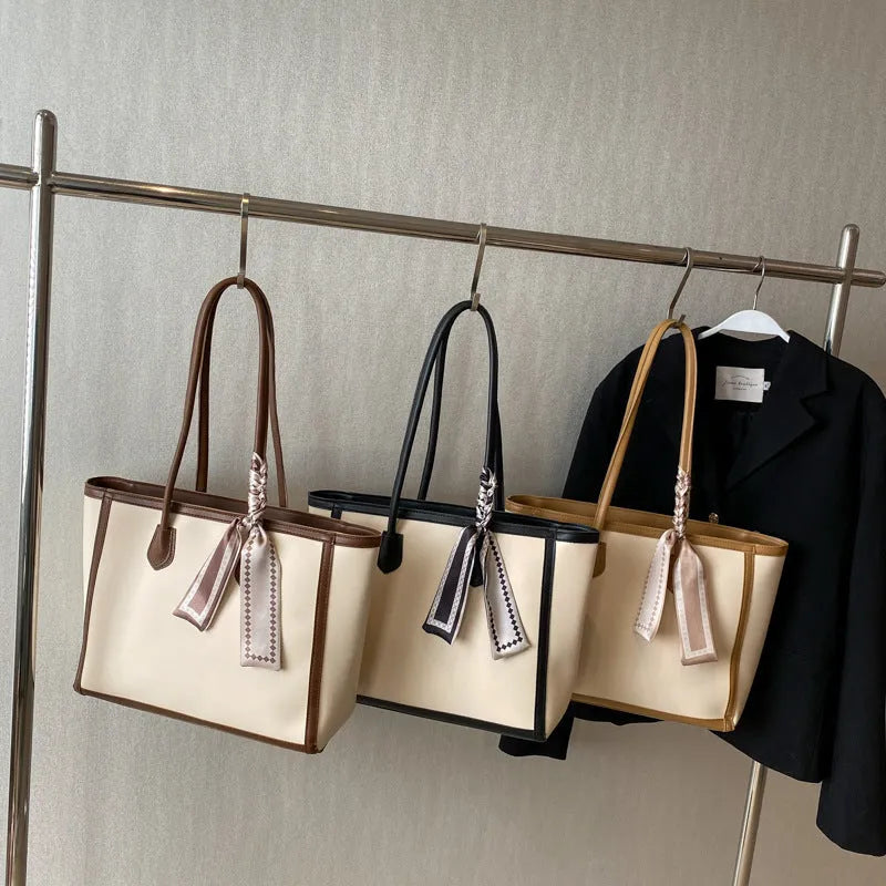 PU shoulder tote bag with zippered internal compartments including phone pocket and change pouch, soft texture winter commuter bag available in black and brown for daily essentials