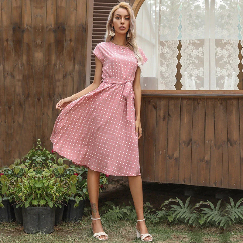 Elegant polka dot midi dress with short sleeves, made of soft viscose fabric and featuring a flattering pleated A-line skirt