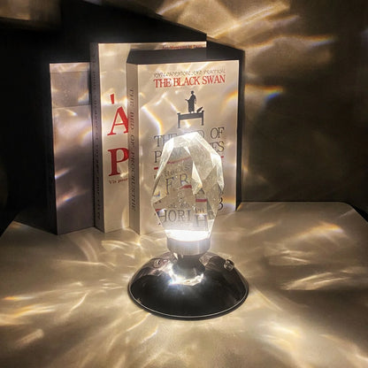 LED Crystal Night Light with remote control and 16 color options on a bedside table