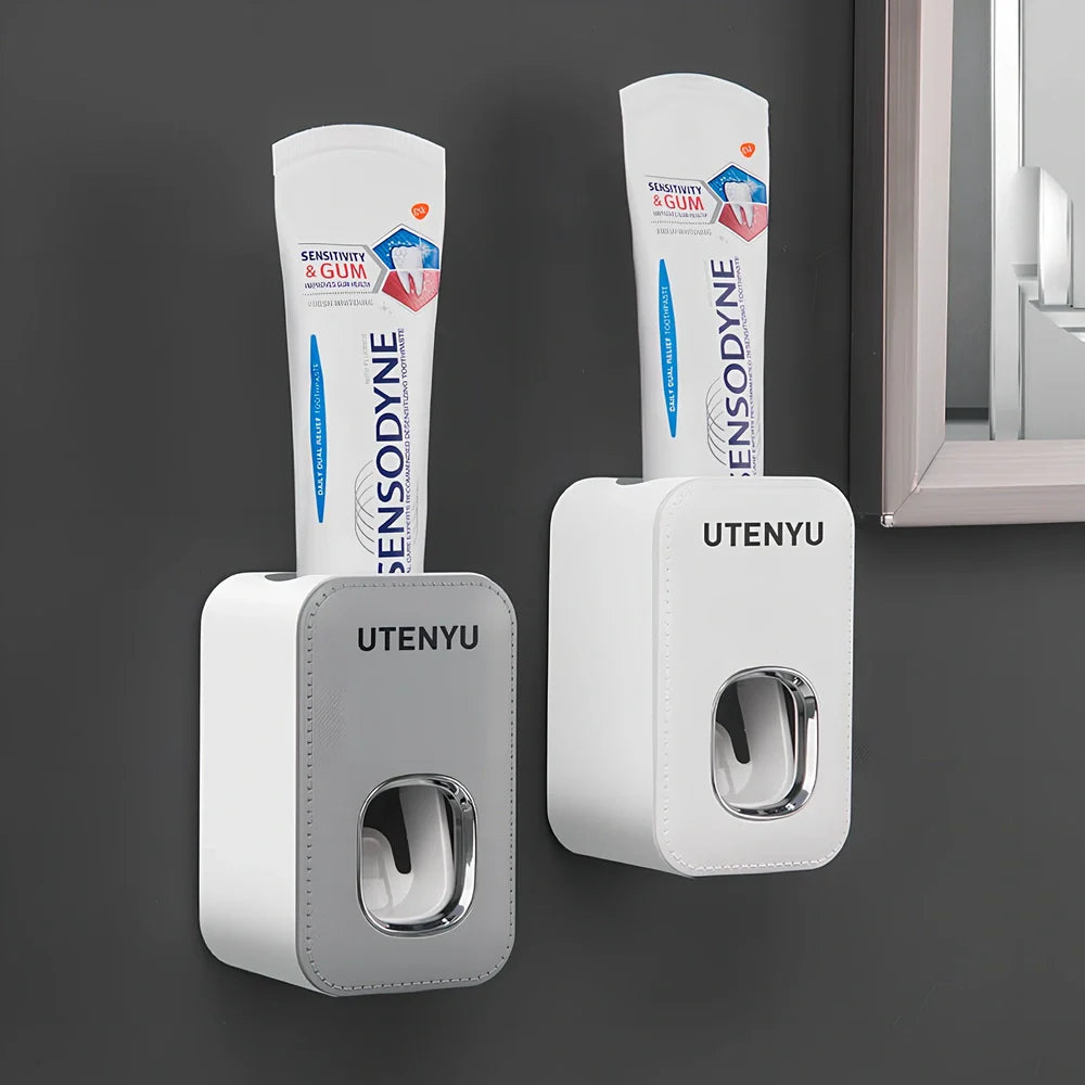 White automatic toothpaste dispenser mounted on bathroom wall with precise 0.8g portion dispensing