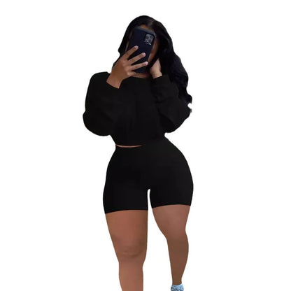 Women's long sleeve off-the-shoulder top and shorts two-piece set in a solid colour.