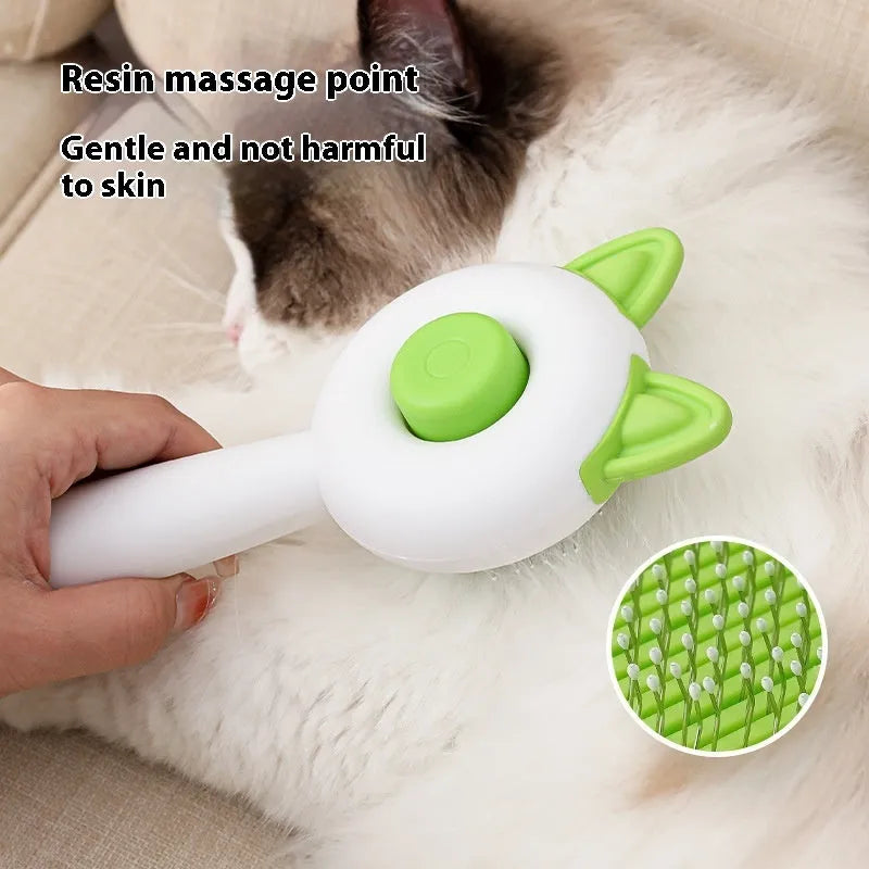 Greenish white pet grooming brush with stainless steel teeth, a push-button, and orange massage beads on the handle.