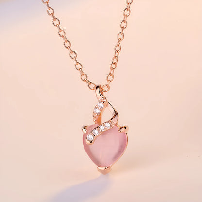 Women's heart-shaped pink crystal pendant necklace with rose gold finish and cross chain
