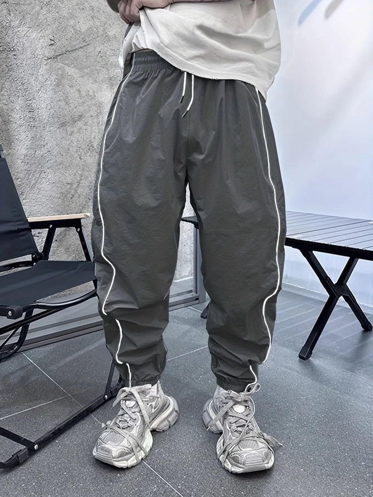 Men's bamboo fibre cropped sports trousers in army green colour showing loose fit and elastic waistband