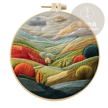 Embroidery DIY landscape kit with bamboo frame, printed fabric, thread, and needles for textile art