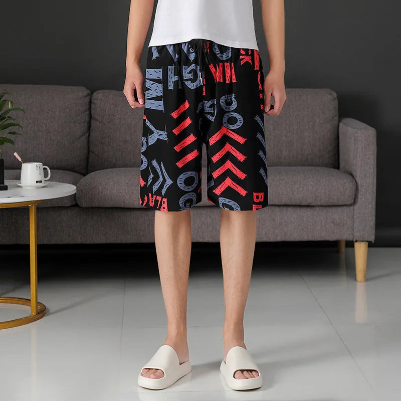 Man wearing loose-fitting striped beach pants made from quick-dry ice silk fabric.