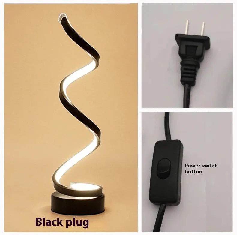 Black and white minimalist LED bedside lamp with aluminium shade and tri-colour dimming on a table