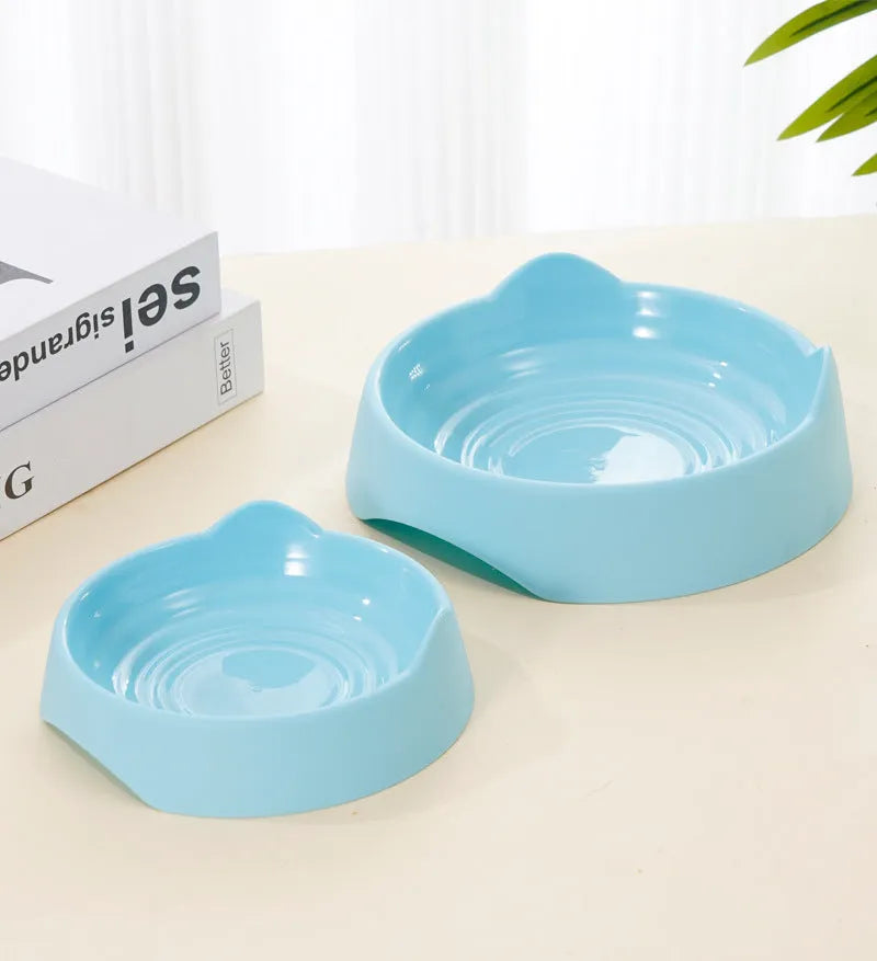 Blue ceramic dog slow feeder bowl with four white cup obstacles inside for puzzle feeding.