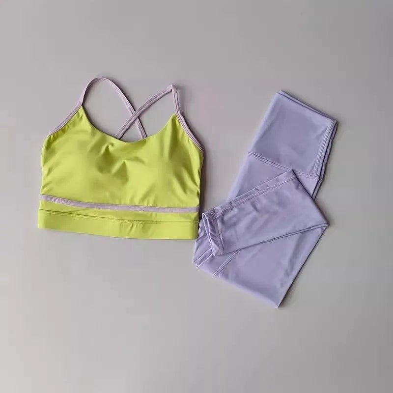 Women's blue and white nylon spandex yoga set with sleeveless tank top and cropped pants.