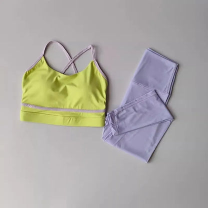 Women's blue and white nylon spandex yoga set with sleeveless tank top and cropped pants.