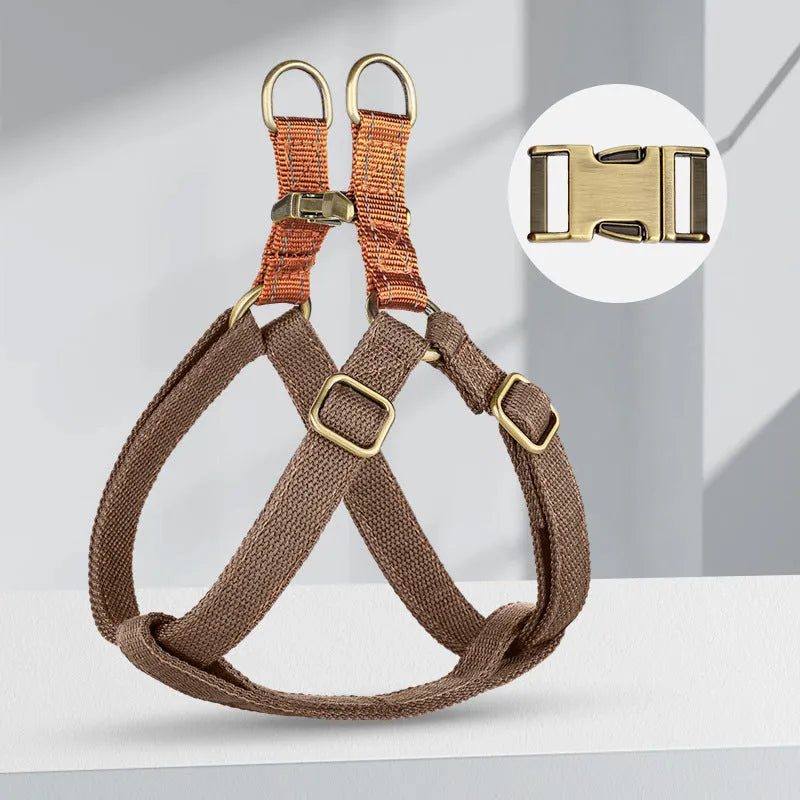 Brown vest-style dog leash with chest harness and alloy fastener on a dog.