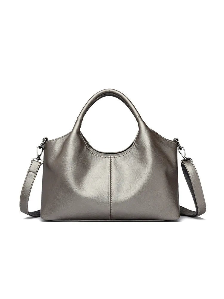 Soft genuine leather women's crossbody bag in beige with large capacity and adjustable strap.