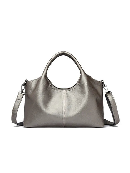 Soft genuine leather women's crossbody bag in beige with large capacity and adjustable strap.