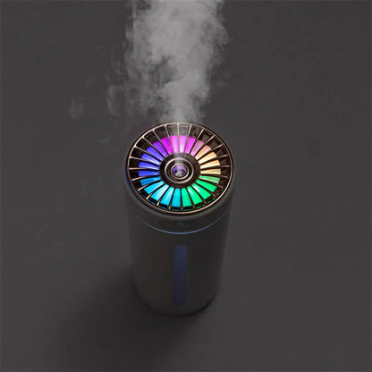 Black wireless car humidifier with colourful LED lights shown in vehicle cup holder