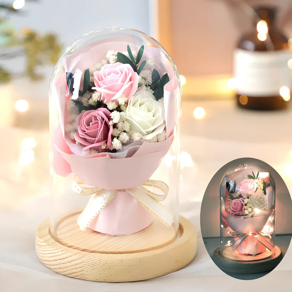 Soap flower bouquet in glass display cover with red roses visible through clear 11.2cm dome