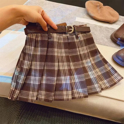 Girls' plaid pleated A-line skirt in cotton blend fabric on a hanger.