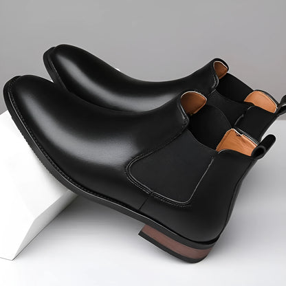Men's black pointed toe Chelsea boots with a decorative sewing thread detail on the artificial PU upper.