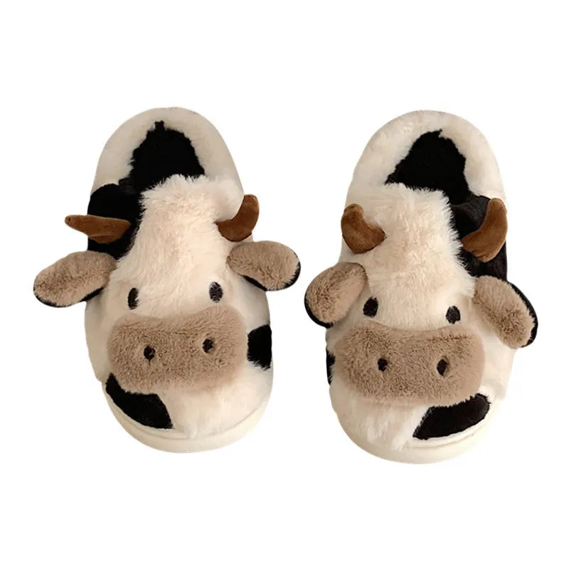 White cow-themed plush slippers with a non-slip textured sole for women.
