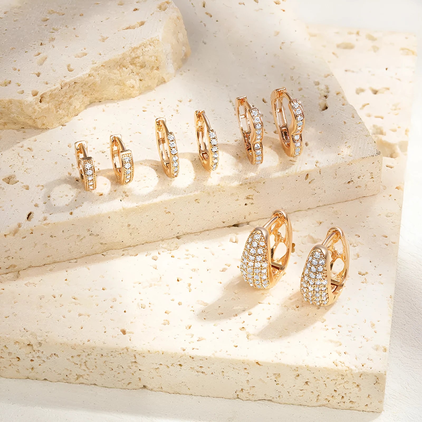 Gold plated heart-shaped clip earrings with a small zircon stone cluster on a copper base.