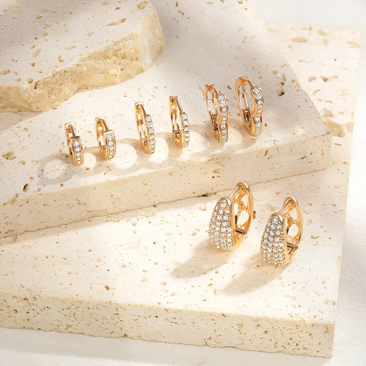 Gold plated heart-shaped clip earrings with a cluster of zircon stones, on a solid copper base.