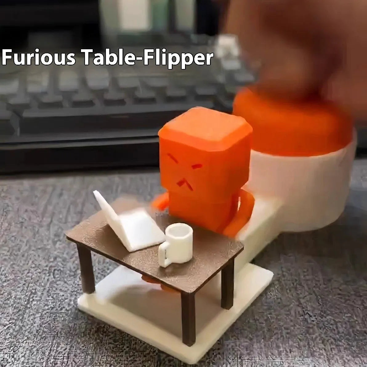 Orange plastic vent decompression toy with turning table mechanism on a desk.