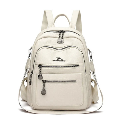 Genuine leather multi-functional commuting backpack with flap pocket, polyester lining, and metal letter patchwork details in black.