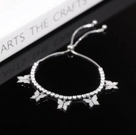 Elegant copper bracelet with delicate butterfly motifs and sparkling zircon accents