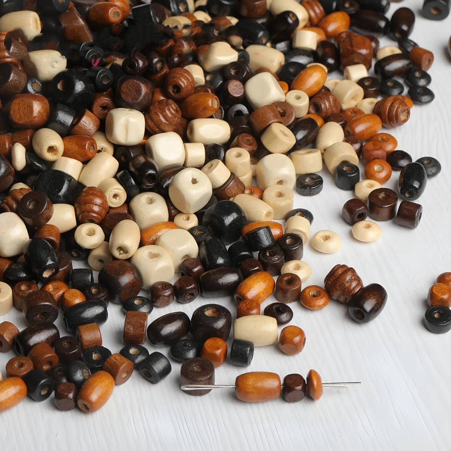 Mixed vintage solid wood beads scattered for DIY jewellery making and craft projects