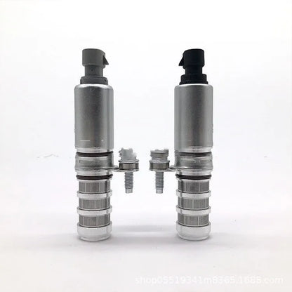 A pair of silver automotive VVT oil control solenoid valves for Buick and Chevrolet models.