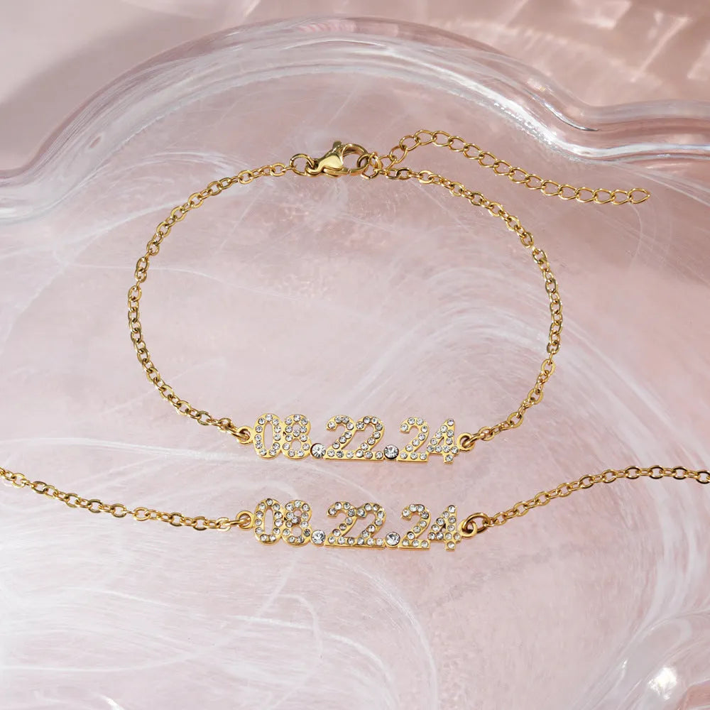 Stainless steel digital bracelet with diamond-set numbers showing time display in gold finish