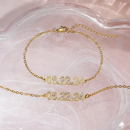 Stainless steel digital bracelet with diamond-set numbers showing time display in gold finish