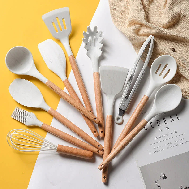 A set of silicone cooking utensils with sturdy wooden handles, designed to withstand high heat up to 446°F.