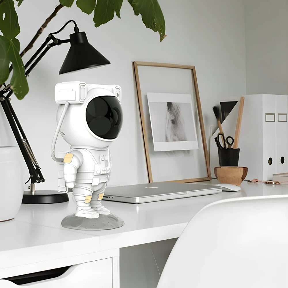 White astronaut-shaped night light projecting star patterns on ceiling with remote control