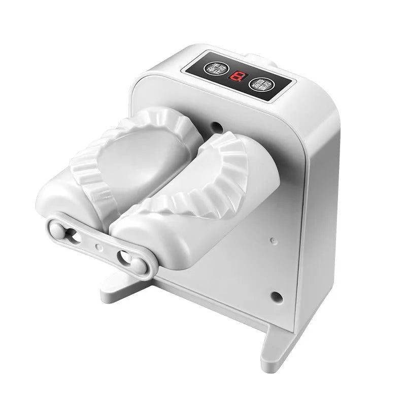 White automatic electric dumpling maker machine with USB cable, brush, and spoon.
