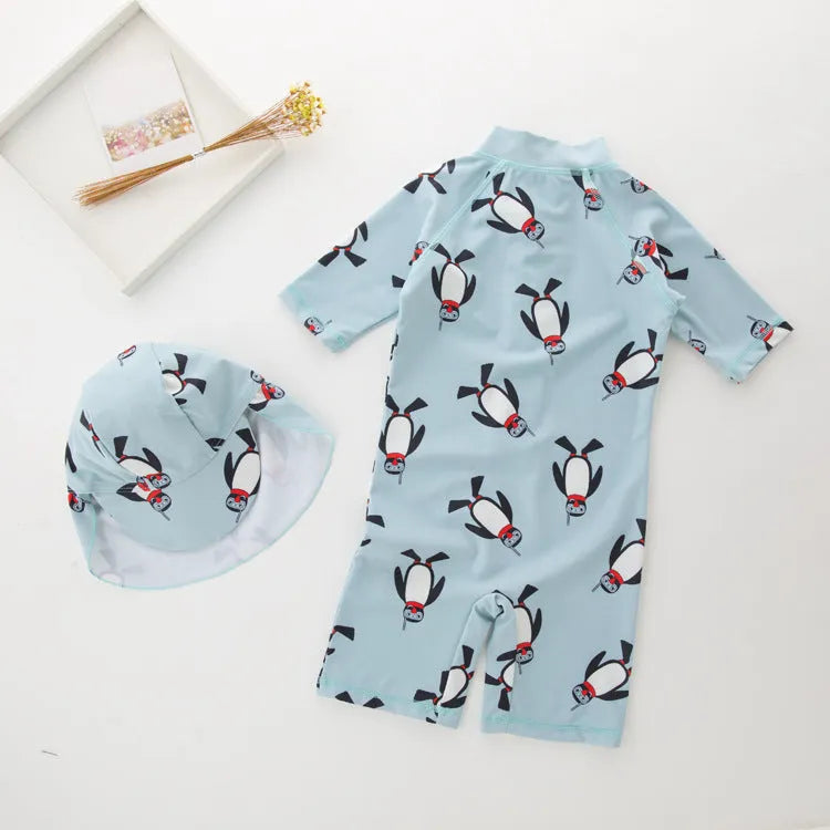 Boy's penguin print long sleeve swimsuit with matching cap for sun protection during water activities