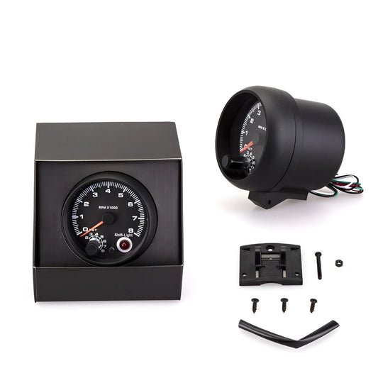 Black automotive tachometer with blue light pointer showing 0-8000 RPM scale.