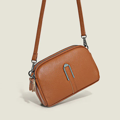 Minimalist top-grain leather crossbody bag in horizontal square shape with inner pockets, available in five colours