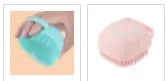 Blue silicone dog bath and massage brush held in a hand.