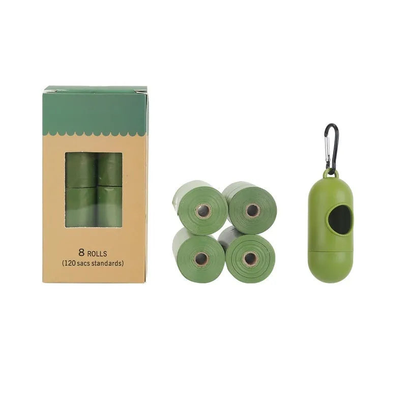 Roll of EPI green degradable pet waste bags next to a transparent dispenser on a grass background.