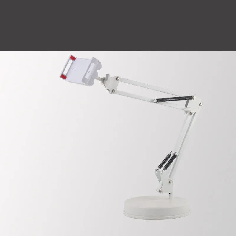 Black universal phone stand with long metal arm and heavy round base on a wooden desk