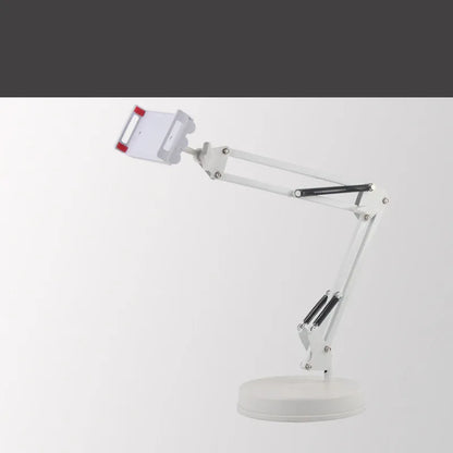 Black universal phone stand with long metal arm and heavy round base on a wooden desk