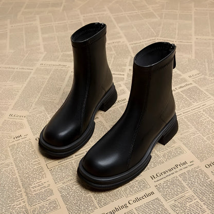 Women's black thick heel ankle boots with back zipper and round toe on flat rubber sole
